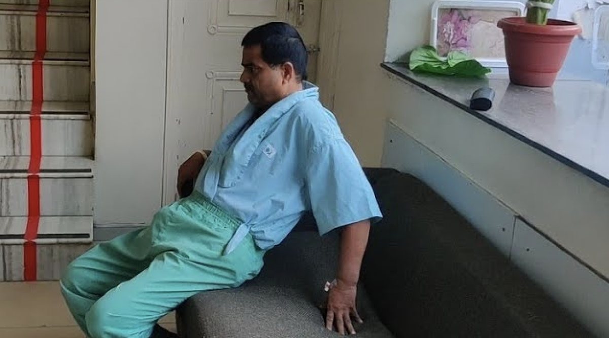 Dr. Ashwani Maichand assessing spinal mobility in a patient with ankylosing spondylitis